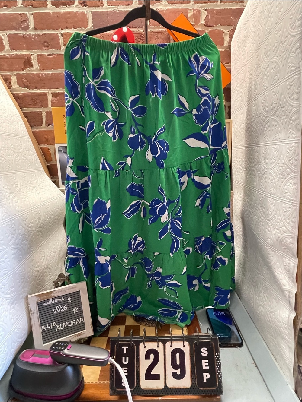 vibrant green tiered maxi skirt features a striking blue and white floral patter